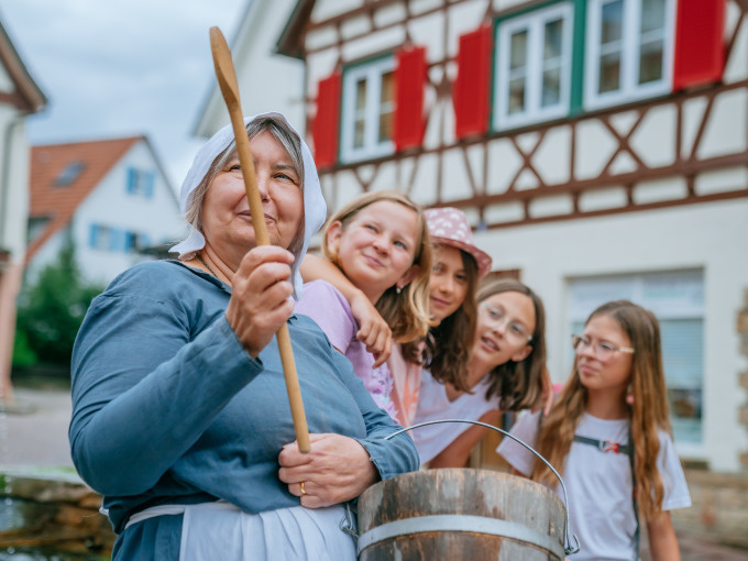 Kitchen maid Elaine shows children the old town